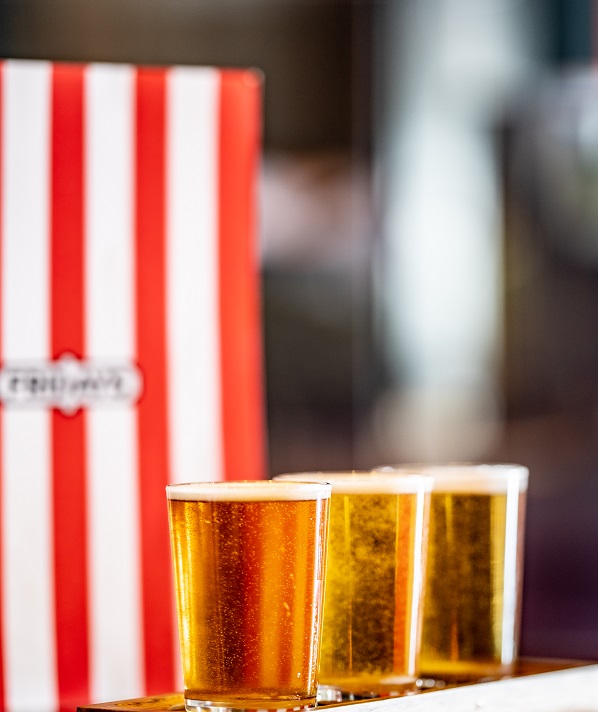 three beers in front of a menu