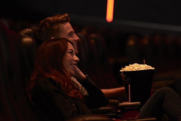 Two people watching a film in a cinema