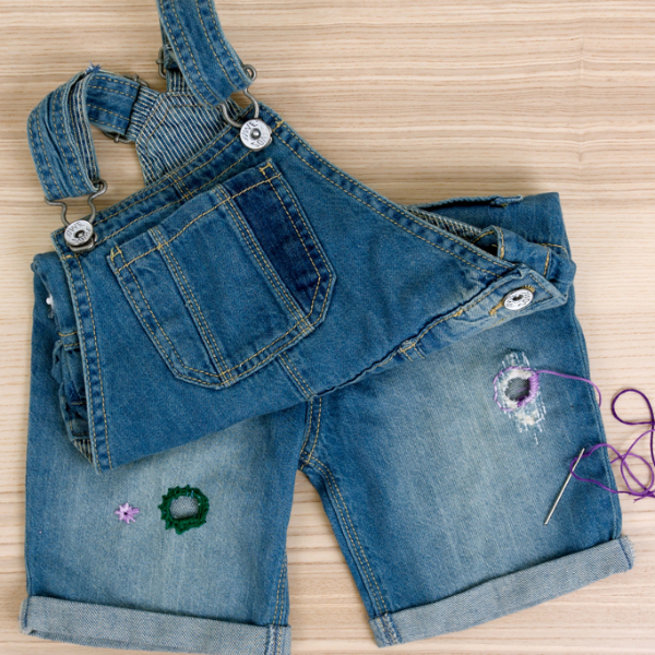 Example of embroidery stitches on denim dungarees